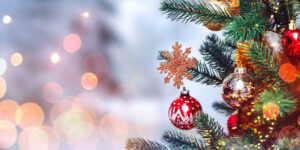 Christmas tree background and Christmas decorations with snow, blurred, sparking, glowing. Happy New Year and Xmas theme